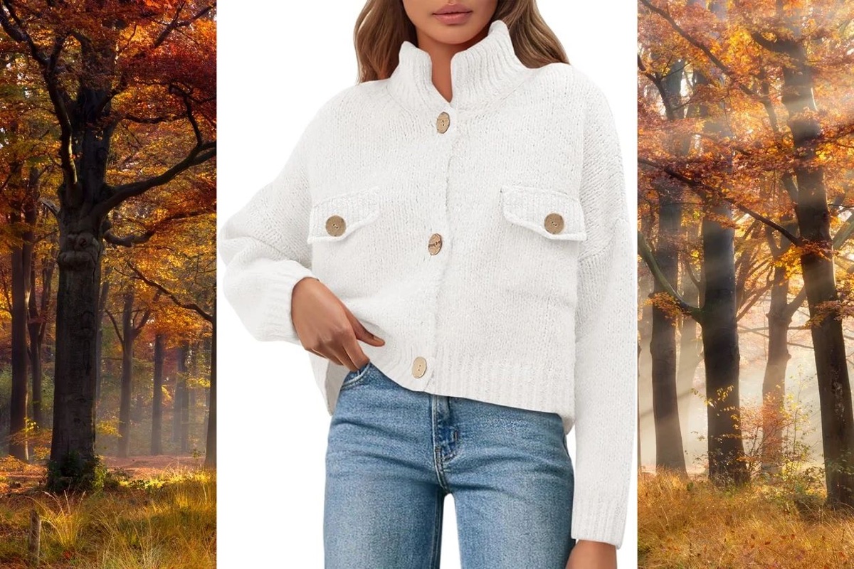 Cream button-front cardigan with jeans, between autumn trees